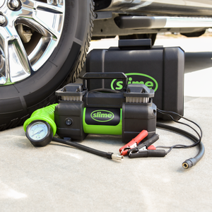
            
                Load image into Gallery viewer, Slime Heavy-Duty Pro Power Tire Inflator #40026 Next to Tire
            
        