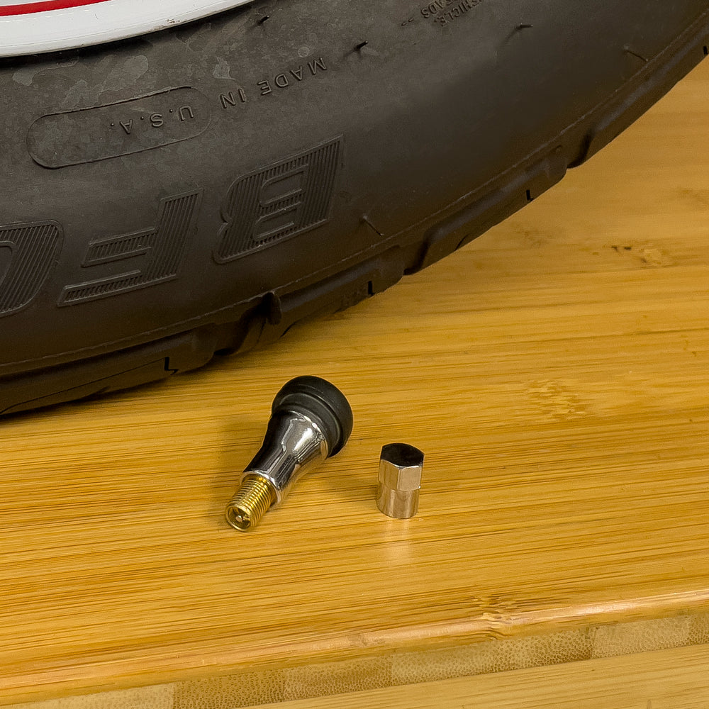 
            
                Load image into Gallery viewer, Slime Chrome Tubeless Tire Valves TR413 #2078-A Next to Tire
            
        